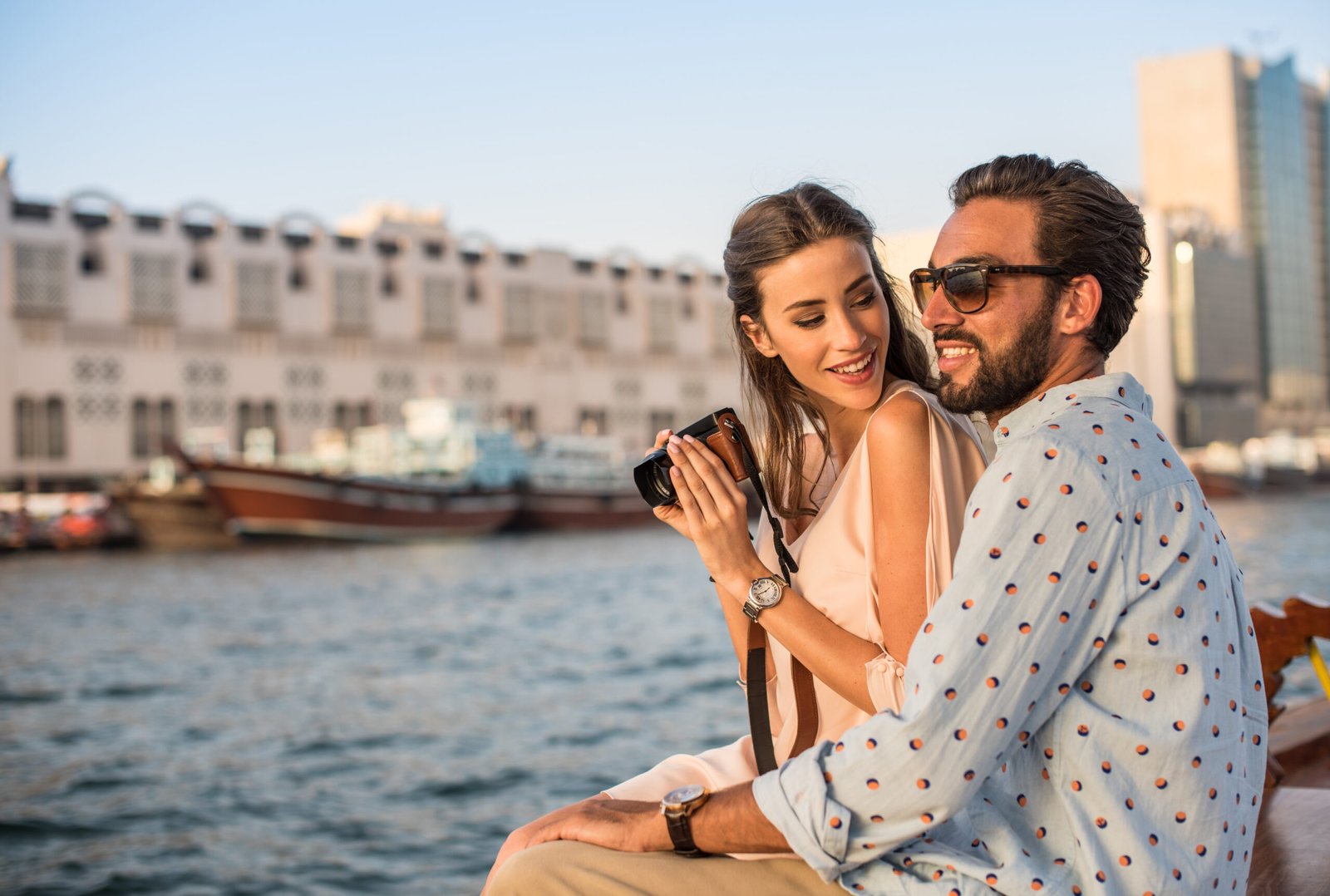 Romantic couple photographing on boat at Dubai marina, United Arab Emirates